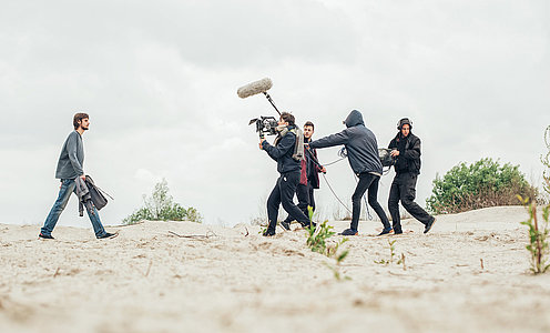 Behind the scene. Film crew filming movie scene outdoor