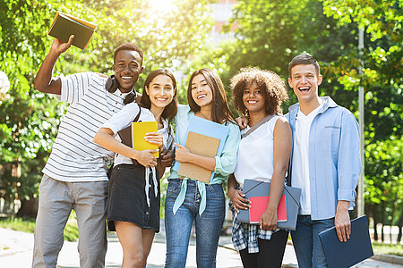 Group of multicultural university students posing outdoors after