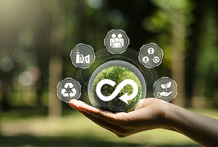 Hand of human holding green earth circular economy icon. Circulating in an endless cycle, Business and world sustainable environment concept..