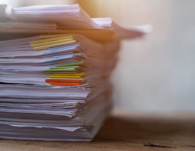 Document, a Stack of documents with a paper clip folder placed on a business desk in a business office.