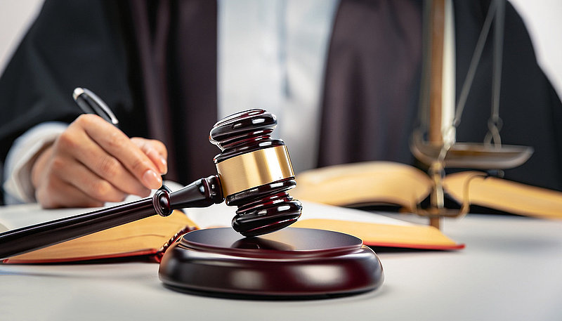 Judges hammer and legal advice figures on the table