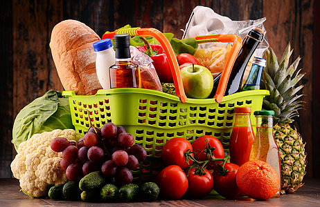 Plastic shopping basket with assorted gorcery products